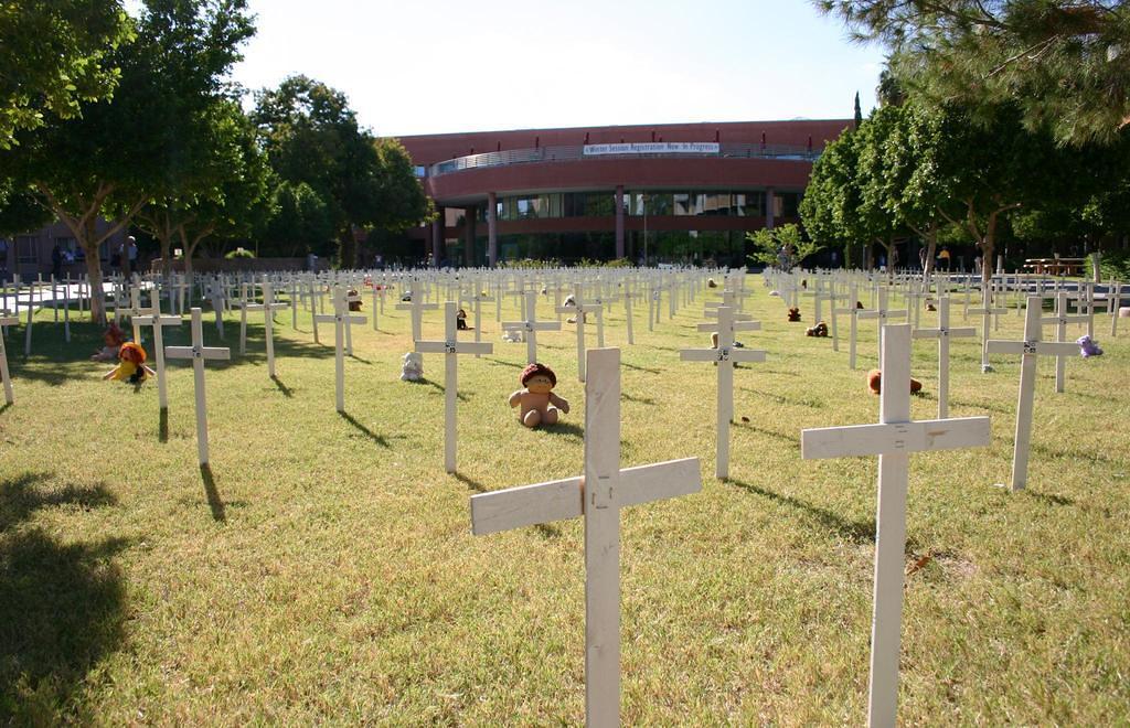 A memorial of crosses was set up in front of the student services building by ASU students.  Each cross represents an American s